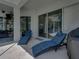 Covered patio area featuring lounge chairs with views of the backyard and pool at 3909 Valrico Grove Dr, Valrico, FL 33594