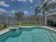 Backyard features a sparkling pool and hot tub inside a screened enclosure at 3909 Valrico Grove Dr, Valrico, FL 33594