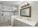 Modern bathroom featuring double sinks, a frameless glass shower enclosure, and stylish fixtures at 4230 Indianapolis Ne St, St Petersburg, FL 33703