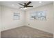 Cozy bedroom featuring two windows for ample natural light and a ceiling fan for comfort at 4230 Indianapolis Ne St, St Petersburg, FL 33703
