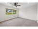 Bright bedroom with a large window offering a view of the well-manicured front yard and neighborhood at 4230 Indianapolis Ne St, St Petersburg, FL 33703