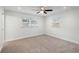 Bright bedroom featuring natural lighting from windows and a ceiling fan for comfortable living at 4230 Indianapolis Ne St, St Petersburg, FL 33703