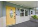 Inviting front porch with a bright yellow door and textured brick detail at 4230 Indianapolis Ne St, St Petersburg, FL 33703