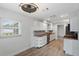 Updated kitchen featuring white cabinets, granite countertops, and modern stainless steel appliances at 4230 Indianapolis Ne St, St Petersburg, FL 33703