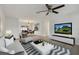 Bright living room features sleek furnishings, modern decor, and a ceiling fan, offering a comfortable and stylish space at 4230 Indianapolis Ne St, St Petersburg, FL 33703