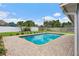 An in-ground pool surrounded by a brick patio and manicured landscape at 4230 Indianapolis Ne St, St Petersburg, FL 33703