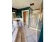 Bathroom with tiled floor, a drop-in tub, a glass-enclosed shower, and dark teal walls at 439 Corbett Rd, Lithia, FL 33547