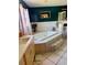 Bathroom features a large tiled bathtub, tiled flooring, vanity, and a large wall mirror at 439 Corbett Rd, Lithia, FL 33547