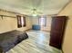 Bedroom with vinyl flooring, ceiling fan, two windows and a brown wardrobe at 439 Corbett Rd, Lithia, FL 33547