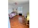 A room featuring wood flooring, a four-poster bed, a window, and a pink chandelier at 439 Corbett Rd, Lithia, FL 33547