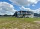 Two-story home with a large porch overlooking a spacious yard and horse property at 439 Corbett Rd, Lithia, FL 33547