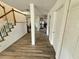 Hallway with wood-look flooring leading to kitchen and stairs with painted risers at 439 Corbett Rd, Lithia, FL 33547