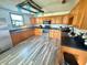 Charming kitchen with stainless steel appliances, oak cabinetry and gray tone vinyl flooring at 439 Corbett Rd, Lithia, FL 33547