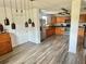 Spacious kitchen with stainless steel appliances, custom lighting, and hardwood-look floors at 439 Corbett Rd, Lithia, FL 33547