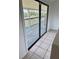 Sliding glass door leading to a patio with weathered wood flooring and backyard at 439 Corbett Rd, Lithia, FL 33547