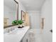 Bright bathroom featuring white cabinetry, marble floors, and shower/tub combo at 4511 S Manhattan Ave # 11, Tampa, FL 33611