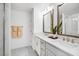 Modern bathroom with a double sink vanity, sleek mirrors, and a glass-enclosed shower for a spa-like experience at 4511 S Manhattan Ave # 11, Tampa, FL 33611