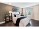 Cozy bedroom featuring neutral colors, a large window, and hardwood floors at 4511 S Manhattan Ave # 11, Tampa, FL 33611