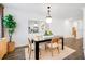 Open dining area featuring a modern light fixture and hardwood floors at 4511 S Manhattan Ave # 11, Tampa, FL 33611