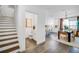 Inviting entryway boasting wood-look tile floors, stairs to the upper level, a half bath, and an open flow to the kitchen at 4511 S Manhattan Ave # 11, Tampa, FL 33611