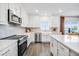 Bright kitchen features stainless steel appliances, an island with white countertops, and stylish backsplash at 4511 S Manhattan Ave # 11, Tampa, FL 33611