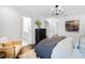 Bright main bedroom featuring a modern chandelier, dark wood floors, and attached bath at 4511 S Manhattan Ave # 11, Tampa, FL 33611