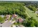 Aerial view of several homes with a golf course and wooded area in the background at 4750 Augusta Ave, Oldsmar, FL 34677
