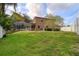 Spacious backyard with lush green grass, privacy fence, and screened in pool area at 4750 Augusta Ave, Oldsmar, FL 34677