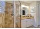 This bathroom has a walk-in shower, granite counters, and shaker cabinets at 4750 Augusta Ave, Oldsmar, FL 34677