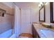 Bathroom featuring granite countertops, dual sinks, tiled shower, and a bathtub at 4750 Augusta Ave, Oldsmar, FL 34677