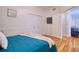 Comfortable bedroom features hardwood floors, closet, and wall mounted television at 4750 Augusta Ave, Oldsmar, FL 34677
