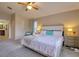 Bedroom featuring a large bed, side tables, and a ceiling fan at 4750 Augusta Ave, Oldsmar, FL 34677