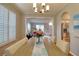 Charming dining room featuring decorative lighting, hardwood floors, views of the living room, and natural light at 4750 Augusta Ave, Oldsmar, FL 34677
