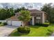 Charming two-story home featuring a well-manicured lawn and an attached two-car garage at 4750 Augusta Ave, Oldsmar, FL 34677