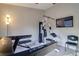 Home gym featuring a multi-station weight machine, treadmill, and wall-mounted TV at 4750 Augusta Ave, Oldsmar, FL 34677