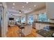 Open concept kitchen with hardwood floors, granite countertops, stainless steel appliances, and a view to the screened-in pool at 4750 Augusta Ave, Oldsmar, FL 34677