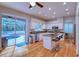 Modern kitchen with stainless steel appliances, breakfast bar, view of pool, and hardwood floors at 4750 Augusta Ave, Oldsmar, FL 34677