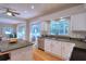 Stylish kitchen featuring stainless steel appliances, a breakfast bar, hardwood floors, and an open concept to other rooms at 4750 Augusta Ave, Oldsmar, FL 34677