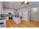 Well-lit kitchen featuring stainless steel appliances, a breakfast bar, pantry, and gorgeous hardwood flooring at 4750 Augusta Ave, Oldsmar, FL 34677