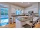 Bright kitchen features stainless steel appliances, a breakfast bar, hardwood floors, and backyard pool views at 4750 Augusta Ave, Oldsmar, FL 34677