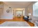 Spacious living room with hardwood floors, neutral paint, views of the dining room, and natural light at 4750 Augusta Ave, Oldsmar, FL 34677