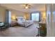 Cozy main bedroom featuring a large window, ceiling fan, and soft natural light at 4750 Augusta Ave, Oldsmar, FL 34677