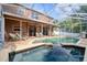 Screened-in pool with outdoor seating, grill, and beautiful backyard views in this lovely backyard space at 4750 Augusta Ave, Oldsmar, FL 34677