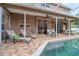 Covered patio with outdoor seating, dining table, ceiling fans, and a view of the sparkling pool at 4750 Augusta Ave, Oldsmar, FL 34677