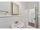 Traditional bathroom showcasing white tiled walls, pedestal sink, and neutral accents at 506 S Melville Ave, Tampa, FL 33606
