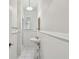Charming bathroom with white tile, pedestal sink, and shower with glass door at 506 S Melville Ave, Tampa, FL 33606