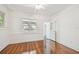 Bright bedroom with wood floors, an open door, and ample natural light at 506 S Melville Ave, Tampa, FL 33606