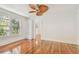 Bright bedroom featuring wood floors, built-in shelving, and ample natural light at 506 S Melville Ave, Tampa, FL 33606