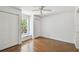 Cozy bedroom with hardwood floors, a ceiling fan, a window seat, and closet space at 506 S Melville Ave, Tampa, FL 33606
