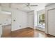 Bright bedroom featuring hardwood floors, a ceiling fan, a window seat, and two closets at 506 S Melville Ave, Tampa, FL 33606